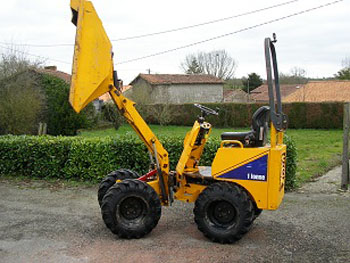 yellow hi-tip dumper with its bucket up in the air, on a gravel road