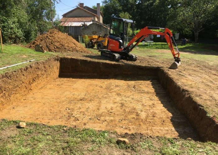 mini-digger in action digging a large hole