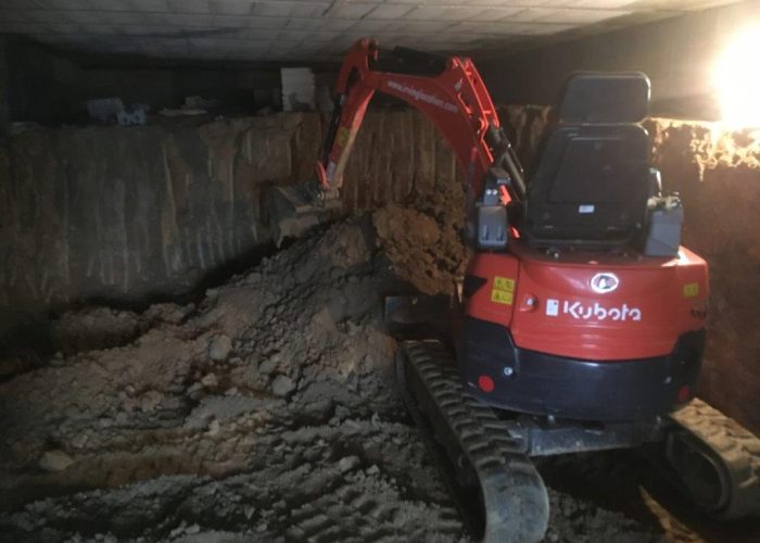 Kubota mini-dgger digging out a basement